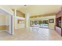 Spacious living room with high ceilings, tile floors, and pool access at 16681 Acapulco Rd, Punta Gorda, FL 33955