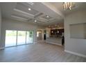 Bright living room with high ceilings, hardwood floors, and sliding doors at 8124 Welsford Rd, Port Charlotte, FL 33981