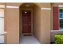 Front entryway with a red door and arched entryway at 7644 Mikasa Dr, Punta Gorda, FL 33950