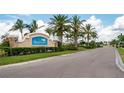 Waterford community entrance with lush landscaping and palm trees at 7644 Mikasa Dr, Punta Gorda, FL 33950