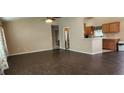 Bright living room with dark wood-look tile floors and ceiling fan at 4530 Irdell Ter, North Port, FL 34288