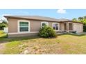 Tan house with a two-car garage and neatly kept lawn at 4530 Irdell Ter, North Port, FL 34288