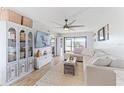 Spacious living room with L-shaped sofa, decorative accents, and hardwood floors at 26485 Rampart Blvd # D3, Punta Gorda, FL 33983