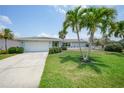 Single-story home with white garage door and manicured lawn at 830 Napoli Ln, Punta Gorda, FL 33950