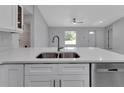 Modern kitchen with white shaker cabinets and stainless steel appliances at 517 Biscayne Dr, Port Charlotte, FL 33953