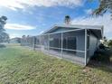 Spacious backyard with screened patio and lush lawn at 75 Annapolis Ln, Rotonda West, FL 33947