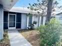 Front entrance with walkway leading to the screened entry at 75 Annapolis Ln, Rotonda West, FL 33947