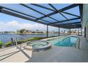 Inviting pool and spa with a covered patio and waterfront views at 1060 San Mateo Dr, Punta Gorda, FL 33950