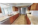 Modern kitchen with granite counters and wood cabinets at 18300 Troon Ave, Port Charlotte, FL 33948
