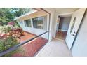 Front entrance with a screened porch and view into the home at 18300 Troon Ave, Port Charlotte, FL 33948