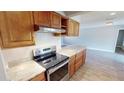 Stainless steel appliances and granite countertops in the kitchen at 18300 Troon Ave, Port Charlotte, FL 33948