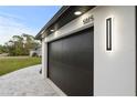 Close-up of garage door with modern lighting and the house number at 5815 Casanova Ave, North Port, FL 34291