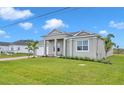 New construction home with a two-car garage and well manicured lawn at 15512 Greenwood Ave, Port Charlotte, FL 33981