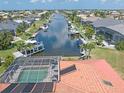 Aerial view of canal-front property with pool and boat docks at 1081 Coronado Dr, Punta Gorda, FL 33950