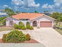Single-Gathering home with tile roof and attached two-car garage at 1081 Coronado Dr, Punta Gorda, FL 33950