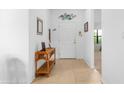 Bright and airy entryway with a console table and decorative wall art at 4093 River Bank Way, Punta Gorda, FL 33980