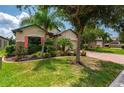 Well-maintained house with palm trees and a brick driveway at 4093 River Bank Way, Punta Gorda, FL 33980
