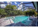 Inviting pool with spa, covered patio and fountain at 13380 Campanile Ct, Venice, FL 34293