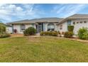 Home's exterior features a charming front entrance with landscaping at 18345 Hottelet Cir, Port Charlotte, FL 33948