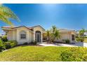 One-story home with a tile roof, lush landscaping and screened entryway at 16446 Belo Ct, Punta Gorda, FL 33955