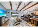 Spacious living room featuring hardwood floors and a large TV at 21220 Pemberton Ave, Port Charlotte, FL 33952