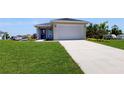 Front view of a single story house with a driveway and landscaping at 30086 Alder Rd, Punta Gorda, FL 33982