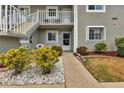 Condo building entrance with well-maintained landscaping and walkway at 3310 Loveland Blvd # 1502, Punta Gorda, FL 33980