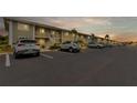 Exterior view of condo building with ample parking and landscaping at 3310 Loveland Blvd # 1502, Punta Gorda, FL 33980