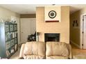 Living room with a brick fireplace and built-in shelving at 3105 Pellam Blvd, Port Charlotte, FL 33948