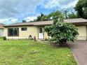 Ranch-style home with a large tree at 1160 Belkton Ave, Port Charlotte, FL 33948