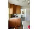 Corner of traditional kitchen with wood cabinetry, countertops, and a view into the house at 27437 Dutch Ave, Punta Gorda, FL 33982