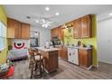 Traditional kitchen features wood cabinetry, an island with seating, and modern appliances at 27437 Dutch Ave, Punta Gorda, FL 33982