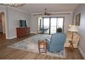 Spacious living room with hardwood floors, access to balcony with water views, and ample natural light at 87 Vivante Blvd # 8742, Punta Gorda, FL 33950