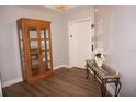 Elegant entryway with wood floors, a display cabinet, and a console table at 87 Vivante Blvd # 8742, Punta Gorda, FL 33950