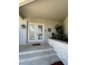 Front entry with double doors, stone planter and a tiled walkway at 65 Ocean Dr, Punta Gorda, FL 33950