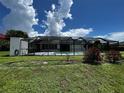 Screened-in pool area with grassy backyard at 4419 Crews Ct, Port Charlotte, FL 33952