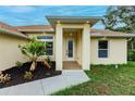 Front entry with decorative door and landscaping at 820 Bowman Ter, Port Charlotte, FL 33953