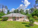 House exterior with palm trees and flag at 7263 Sablon Rd, North Port, FL 34291