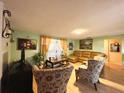Spacious living room with leather furniture and hardwood floors at 1629 Birchcrest Blvd, Port Charlotte, FL 33952