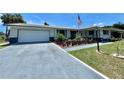 Ranch-style home with white exterior and landscaping at 1629 Birchcrest Blvd, Port Charlotte, FL 33952