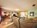 Open concept living and dining area with hardwood floors at 1629 Birchcrest Blvd, Port Charlotte, FL 33952