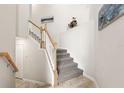 Stylish staircase with carpeted steps and white railings at 15999 Grassland Ln # 3221, Punta Gorda, FL 33982