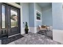 Relaxing front porch with rocking chairs and stylish decor at 9978 Audrey St, Port Charlotte, FL 33981