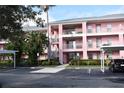 Two-story pink building with parking and landscaping at 2061 Willow Hammock Cir # C-301, Punta Gorda, FL 33983