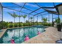 Screened-in pool and spa with a view of lush landscaping at 43789 Cattleman Dr, Punta Gorda, FL 33982