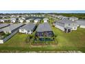 Aerial view of a house with a private pool at 43789 Cattleman Dr, Punta Gorda, FL 33982
