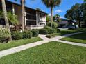 Condo building and surrounding landscape, showing parking area at 1515 Forrest Nelson Blvd # E106, Port Charlotte, FL 33952