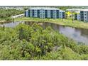 Condo building near a pond and lush landscaping at 14121 Heritage Landing Blvd # 731, Punta Gorda, FL 33955