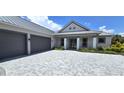 Two-story house with gray double door entry, gray double garage doors, and a paved driveway at 28976 Gin Ln, Punta Gorda, FL 33982