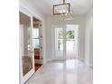 Bright entryway with double doors opening to a patio, and shiny floors at 28992 Gin Ln, Punta Gorda, FL 33982